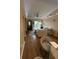Open living room features a large sofa and a balcony view at 12021 Villanova Dr # 111, Orlando, FL 32837