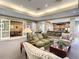 Open-concept living room with neutral colors, plush seating, and access to dining and bar areas at 12021 Villanova Dr # 111, Orlando, FL 32837
