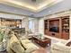 Spacious living room with coffered ceiling, comfortable seating, and built-in entertainment center at 12021 Villanova Dr # 111, Orlando, FL 32837