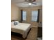 Comfortable bedroom with a big bed, pillows, two windows, and wood floor at 12021 Villanova Dr # 111, Orlando, FL 32837