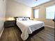 Comfortable bedroom with wood flooring and large windows offering natural light at 12021 Villanova Dr # 111, Orlando, FL 32837