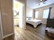 Bedroom with ensuite bathroom featuring wood floors and a ceiling fan at 12021 Villanova Dr # 111, Orlando, FL 32837