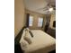 Comfortable main bedroom with a big bed, pillows, two windows, and wood floor at 12021 Villanova Dr # 111, Orlando, FL 32837
