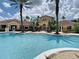Spacious pool area with lounge chairs, surrounded by manicured landscaping and community buildings at 12021 Villanova Dr # 111, Orlando, FL 32837