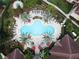 Aerial view of a uniquely shaped swimming pool with palm trees and red umbrellas at 12021 Villanova Dr # 111, Orlando, FL 32837