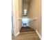 Staircase has wood looking stairs with white risers and a white handrail leading downstairs at 12021 Villanova Dr # 111, Orlando, FL 32837