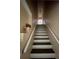 Interior stairway featuring brown steps and white risers, leading to the upper level of the home at 12021 Villanova Dr # 111, Orlando, FL 32837