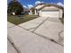 Inviting single-story home featuring an attached garage and well manicured landscaping at 123 Moss Bluff Rd, Kissimmee, FL 34746