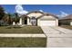 Charming single-story home with a well-manicured lawn and mature palm trees at 123 Moss Bluff Rd, Kissimmee, FL 34746