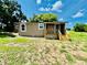 Exterior view of the back of the home, highlighting the backyard and the new deck at 13 E 8Th St, Frostproof, FL 33843
