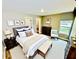 Comfortable bedroom featuring a neutral color palette, dark furniture, and a bench at 13 E 8Th St, Frostproof, FL 33843