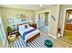 Bedroom featuring natural light, wood floors, modern decor, and closet space at 13 E 8Th St, Frostproof, FL 33843