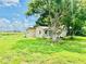 Quaint single story home with neutral paint, mature landscaping and a well-maintained lawn at 13 E 8Th St, Frostproof, FL 33843