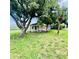 Charming single-story home nestled beneath a large shade tree with lush green lawn at 13 E 8Th St, Frostproof, FL 33843