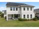 Back exterior view highlighting the covered patio, well-manicured lawn, and seamless indoor-outdoor living at 14081 Gullstrand Ave, Orlando, FL 32827