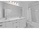 A well-lit bathroom showcasing a double sink vanity and a shower with white subway tile at 14081 Gullstrand Ave, Orlando, FL 32827
