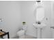 Clean and bright powder room with pedestal sink, modern fixtures, and neutral decor at 14081 Gullstrand Ave, Orlando, FL 32827