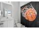 Bathroom featuring a basketball themed shower curtain and granite countertop at 14081 Gullstrand Ave, Orlando, FL 32827