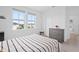 Bedroom with striped bedding, two windows, a gray dresser, and basketball decor at 14081 Gullstrand Ave, Orlando, FL 32827