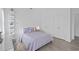 Bright bedroom with light purple bedding, sleek desktop, and built-in shelving at 14081 Gullstrand Ave, Orlando, FL 32827