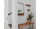 Cozy entryway with stylish bench, decorative mirror, and charming wallpaper accent at 14081 Gullstrand Ave, Orlando, FL 32827