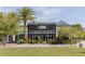 Striking commercial building exterior with lush landscaping, palm trees and ample parking at 14081 Gullstrand Ave, Orlando, FL 32827