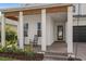 Inviting front porch with rocking chairs, white pillars, and a brick paved walkway leading to the front door at 14081 Gullstrand Ave, Orlando, FL 32827