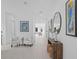 Bright and airy hallway adorned with elegant decor, stylish furnishings, and beautiful hardwood flooring at 14081 Gullstrand Ave, Orlando, FL 32827