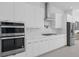Beautiful kitchen with built in stainless steel appliances, white countertops and cabinets at 14081 Gullstrand Ave, Orlando, FL 32827