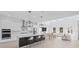 Open kitchen featuring skylights, large island, stainless appliances, and modern pendant lights at 14081 Gullstrand Ave, Orlando, FL 32827