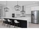 Modern kitchen featuring a spacious island with seating and stainless steel appliances at 14081 Gullstrand Ave, Orlando, FL 32827