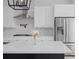 Close up of a modern kitchen with stainless steel appliances and white countertops at 14081 Gullstrand Ave, Orlando, FL 32827