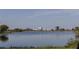 A scenic lake view with modern buildings in the distance, showcasing the community's natural beauty at 14081 Gullstrand Ave, Orlando, FL 32827