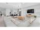 Open-concept living space with modern decor, featuring a sleek kitchen and comfortable seating at 14081 Gullstrand Ave, Orlando, FL 32827