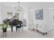 Sophisticated living room with a grand piano, stylish lighting, and tasteful decor perfect for entertaining guests at 14081 Gullstrand Ave, Orlando, FL 32827