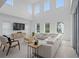 Bright living room featuring high ceilings and a comfortable, modern white sectional sofa at 14081 Gullstrand Ave, Orlando, FL 32827