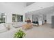 Bright, open living area with white sectional, flowing into dining and kitchen spaces at 14081 Gullstrand Ave, Orlando, FL 32827