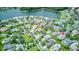 Aerial view of a residential neighborhood located near a lake and lush greenery at 142 Largo Dr, Poinciana, FL 34759