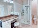 Bathroom showcasing granite countertops, a glass shower, and neutral tile flooring at 142 Largo Dr, Poinciana, FL 34759