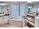 Bright bathroom featuring a soaking tub, granite countertops, and vessel sinks at 142 Largo Dr, Poinciana, FL 34759