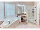 Luxurious bathroom with a standalone tub, separate shower, and elegant vanity area at 142 Largo Dr, Poinciana, FL 34759