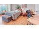 Serene bedroom with a comfortable bed, stylish ottoman, and a functional workspace at 142 Largo Dr, Poinciana, FL 34759