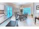 Inviting dining area featuring a modern chandelier, stylish table setting, and ample natural light at 142 Largo Dr, Poinciana, FL 34759
