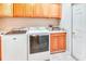 Functional laundry room with cabinets, countertop space, a washing machine, and a dryer at 142 Largo Dr, Poinciana, FL 34759