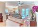 Bright living room with tile floors, comfortable furniture, and a view of the outdoor patio at 142 Largo Dr, Poinciana, FL 34759