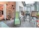 Charming patio with stone flooring, bar height chairs and table, privacy screening and cheerful decorative accents at 142 Largo Dr, Poinciana, FL 34759