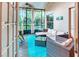 Screened-in patio with wicker furniture, ample seating, and views of the landscaped backyard at 142 Largo Dr, Poinciana, FL 34759