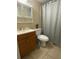 Cozy bathroom with a tub, toilet, vanity, and patterned shower curtain at 167 Scottsdale Sq # 167, Winter Park, FL 32792