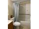 Simple bathroom with a tub, toilet, vanity, and blue patterned shower curtain at 167 Scottsdale Sq # 167, Winter Park, FL 32792