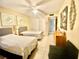 Comfortable bedroom with two twin beds, ceiling fan, closet, and tile flooring at 167 Scottsdale Sq # 167, Winter Park, FL 32792